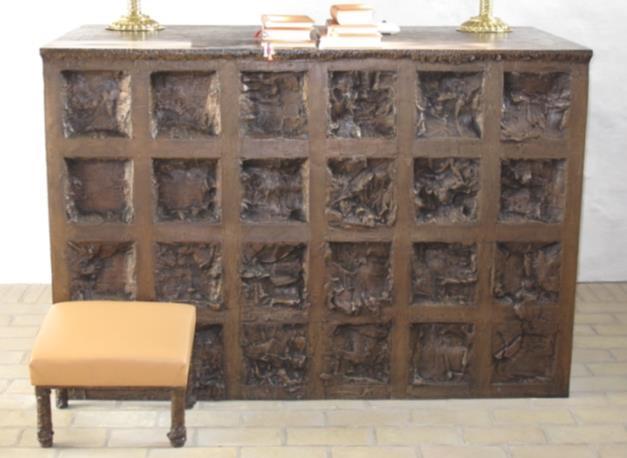 Alterparti Per Kirkebys alterbord er et gyldenbronze bord, bestående af et gitter med 24 felter på forsiden og 12 felter på hvert endestykke.