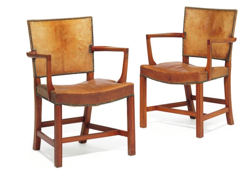 1095 KAARE KLINT b. Frederiksberg 1888, d. Copenhagen 1954 The Red Chair. A pair of Cuban mahogany armchairs. Seat and back upholstered with patinated Niger leather, fitted with brass nails.