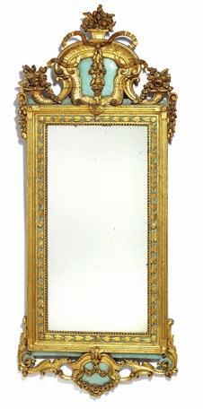634 A Swedish giltwood and blue painted mirror, carved with vases and flowers.