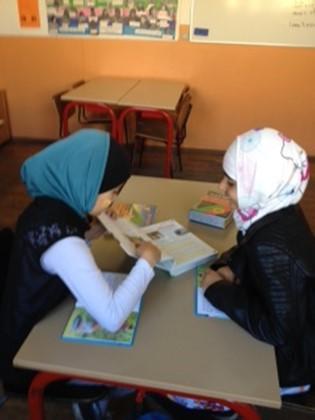 in a written text. Two students having fun while reading.