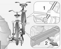 Hold fast i stellet (1) på den bageste cykel med én hånd og træk i stroppen (2) for at frigøre holderen.