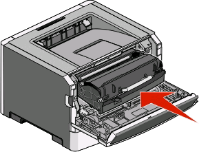 2 Løft og træk enheden der indeholder fotokonduktorsættet og tonerkassetten ud af printeren. Anbring den på en ren, plan overflade. Advarsel!