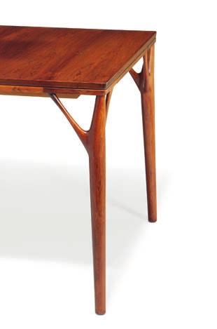 1349 DANISH CABINETMAKER Rectangular Brazilian rosewood dining table with extension and foldable leaf underneath top. Rail integrated with sculpturally shaped "fork" legs. This example made 1960s. H.
