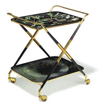 DKK 20,000 / 2,700 1354 PIERO FORNASETTI b. 1913, d. Milano 1988 Small tray table mounted on castors. Brass details and a collapse mechanism for folding the cart.
