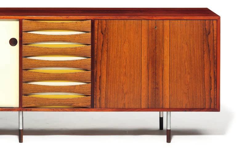 1384 ARNE VODDER b. 1926, d. 2009 "Credenza". Brazilian rosewood sideboard on six round steel legs with rosewood shoes. Front with two reversible sliding doors with resp.