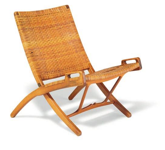1168 1168 HANS J. WEGNER b. Tønder 1914, d. Gentofte 2007 "JH 512". A patinated oak folding chair, seat and back with woven cane. Model JH 512. Designed 1949.