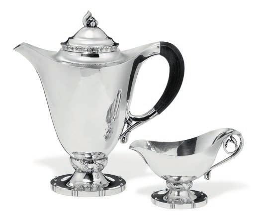 1044 1044 GEORG JENSEN b. Rådvad 1866, d. Hellerup 1935 Sterling silver coffeepot and creamer. Oval bases with beads. Coffeepot's handle of carved ebony. Georg Jensen resp.