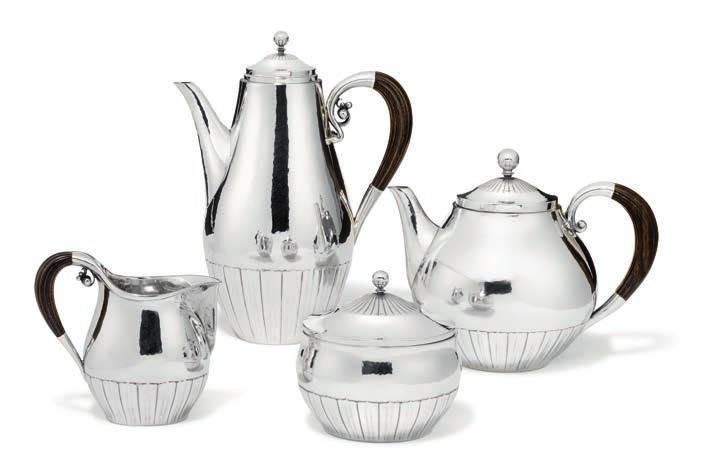 1046 1046 JOHAN ROHDE b. Randers 1856, d. Hellerup 1935 Hammered sterling silver coffee- and tea set. Comprising a coffeepot, a teapot, creamer and sugar bowl and cover. Handles of carved ebony.