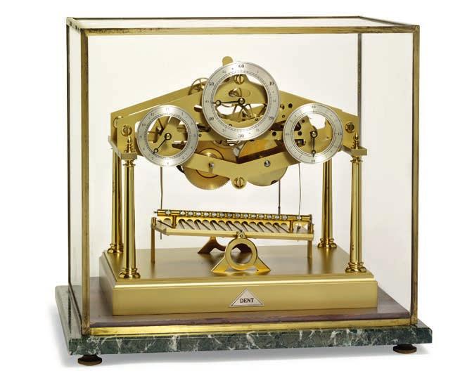 1077 DENT, LONDON "Congreve Rolling Ball Clock". Table clock by Dent with fusee movement, three silvered dials, on a gilded brass base, the back engraved "Ser. no.