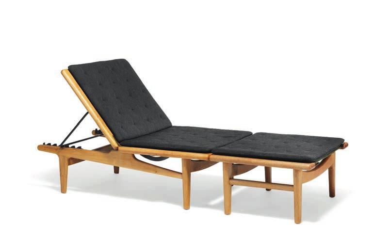 1233 1233 HANS J. WEGNER b. Tønder 1914, d. Gentofte 2007 "GE 1". A solid oak daybed in two sections, adjustable back with iron fittings. Loose cushions upholstered with charcoal grey wool.
