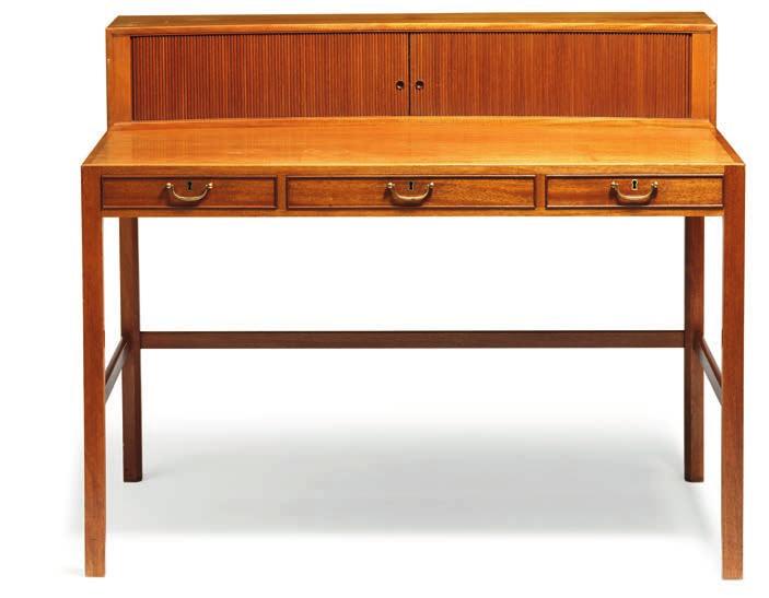 996 JACOB KJÆR b. 1896, d. 1957 A mahogany lady s desk. Front with three profiled drawers with brass handles. Table top with storage comparment with tambour door front, interior with small shelves.