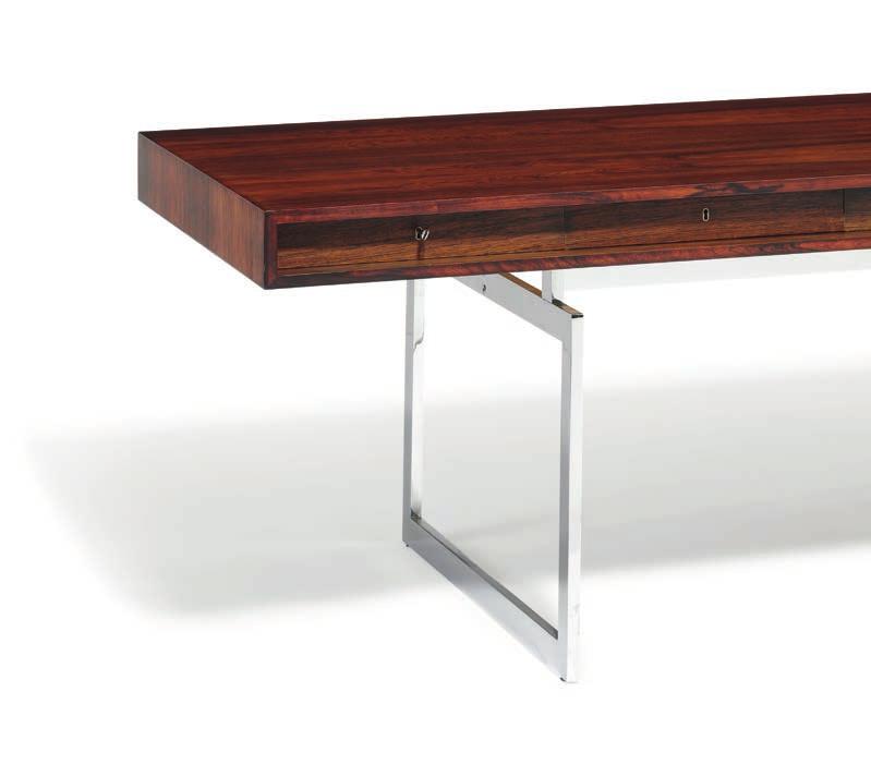 999 999 BODIL KJÆR b. Hatting 1932 A freestanding Brazilian rosewood desk with two matching drawer sections on castors. Chromed steel frame and castors. Desk's rail with four integrated drawers.