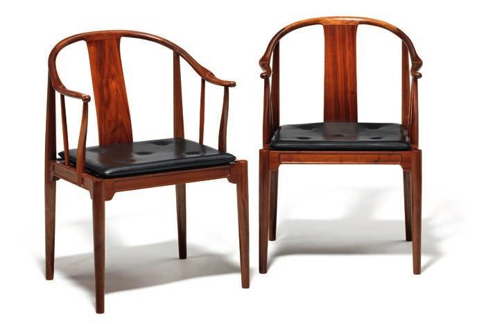 1071 HANS J. WEGNER b. Tønder 1914, d. Gentofte 2007 "China chair". A pair of nut wood armchairs. Loose seat cushion upholstered with black leather, fitted with buttons.