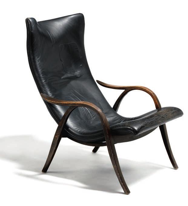 1076 FRITS HENNINGSEN b. 1889, d. 1965 Easy chair with curved frame of dark stained wood. Seat and back upholstered with black leather. This example made circa 1950s by cabinetmaker Frits Henningsen.