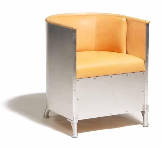 000 / 2.400-2.700 565 MATS THESELIUS b. 1956 "Alminum Chair". Armchair with frame of wood covered with polished aluminum. Inside of seat and back covered with natural leather. Edge on back of beech.