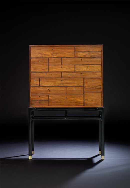 619 J. BERG Free-standing cabinet of rosewood on black painted "Chinese" frame. Front with 19 drawers in various dimensions. Edges and each drawer with profiles. Keyholes of brass.