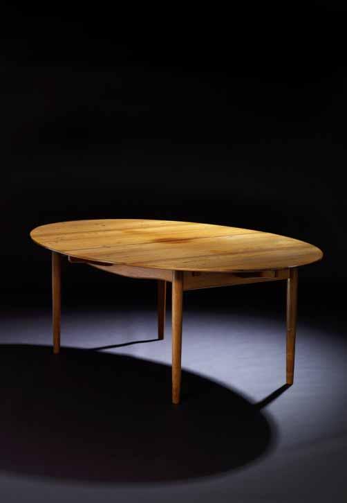 INTERNATIONAL DESIGN 621 FINN JUHL b. 1912, d. 1989 "Judas Table". Oval dining table of rosewood. Top with circular inlays of silver. Two extra leaves.