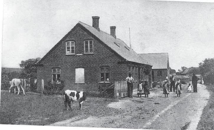 Parti fra nuværende Sdr. Øsløsvej, med smed Holmstrøms hus, nuv. 14, i forgrunden. Ca. 1910. virke.